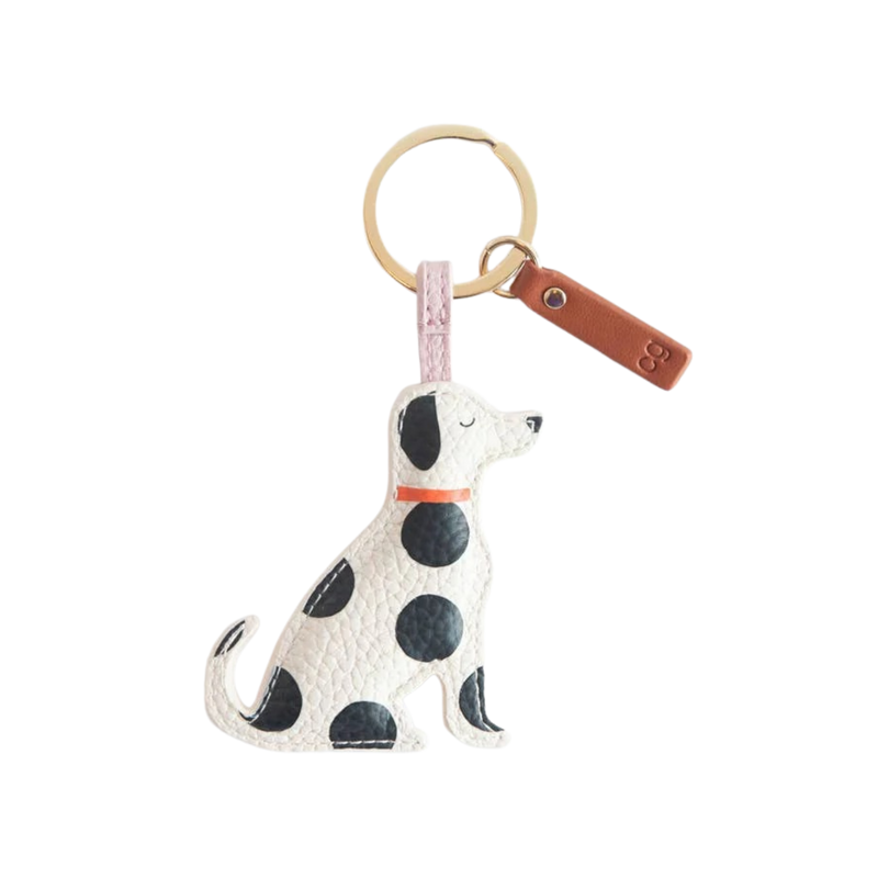 Dog-shaped keychain with polka dot pattern on a white background