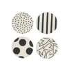 Four round coasters with black and white patterns on a white background