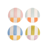 Four round ceramic coasters with colorful striped patterns on a white background