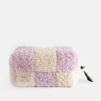 Patchwork-style pouch with pink and beige squares on a white background