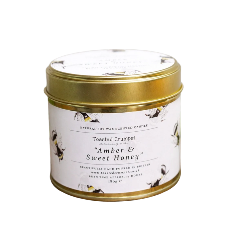 Scented candle in a tin with a gold lid on a white background