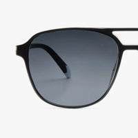 Black sunglasses with gradient lenses on a white background