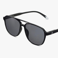 Black sunglasses with dark lenses on a white background