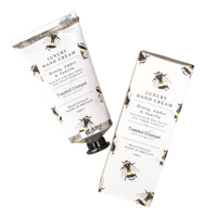 Luxury hand cream with bee design on a white background