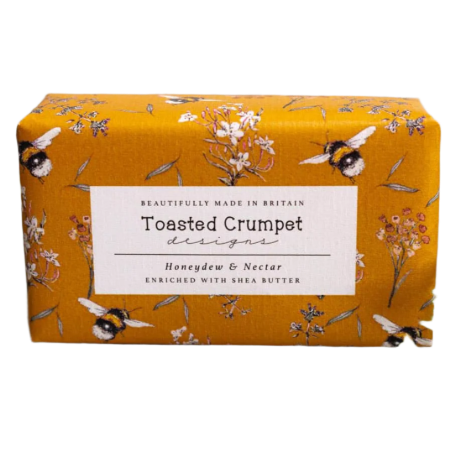 Bar of soap with 'Toasted Crumpet' packaging featuring floral and bee design on a white background.