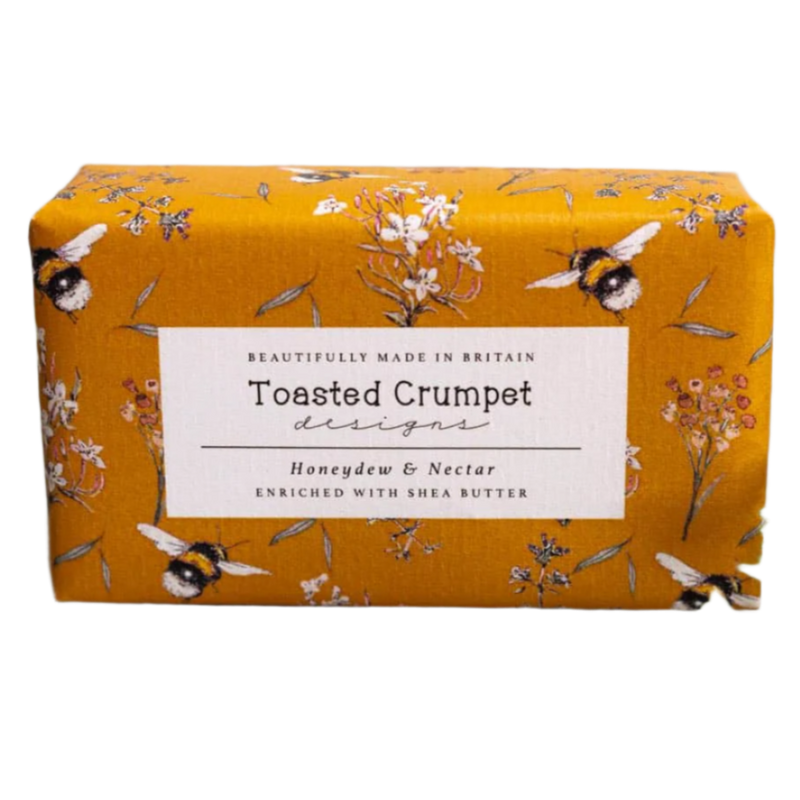 Bar of soap with 'Toasted Crumpet' packaging featuring floral and bee design on a white background.