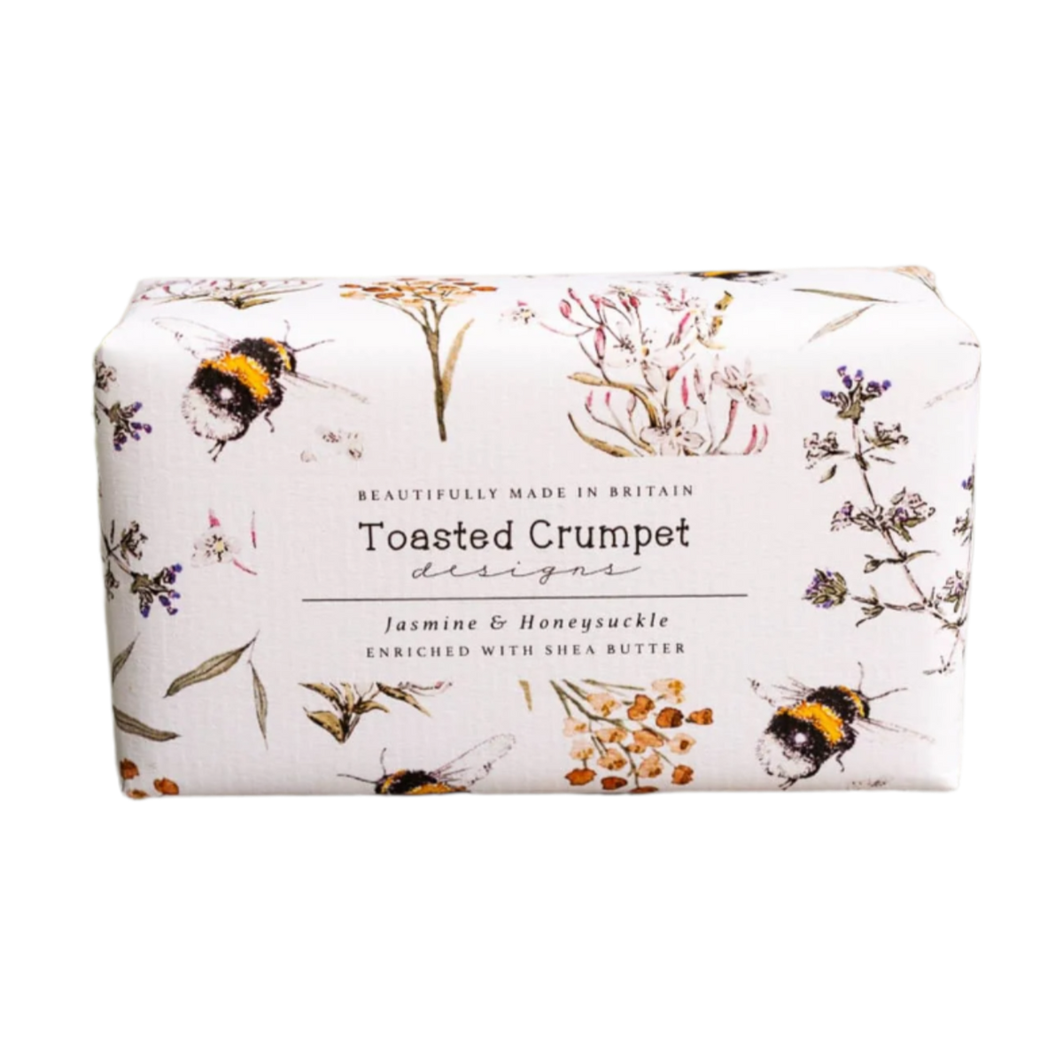 Bar of soap with floral and bee design packaging on a wooden surface