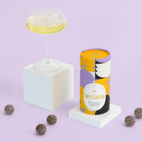 Cylindrical product with decorative design on a light purple background