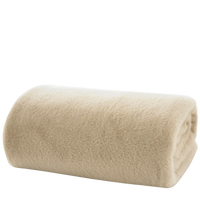 Rolled beige throw on a white background