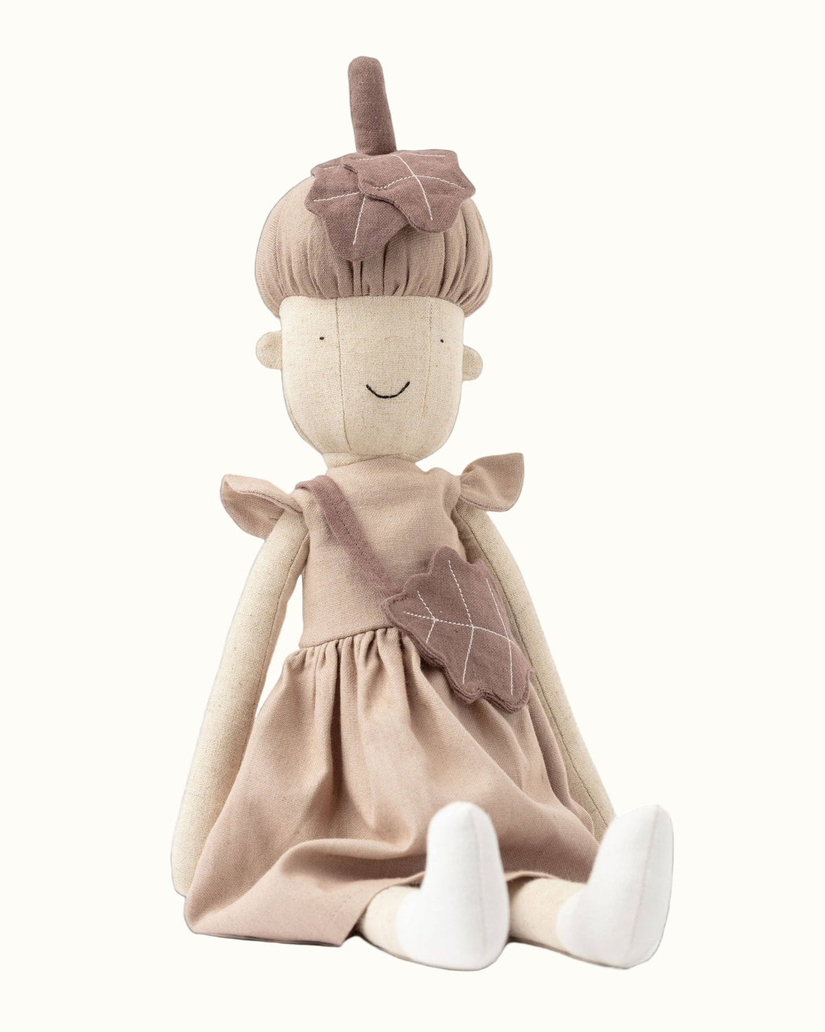 Stuffed doll with a dress and headband on a white background