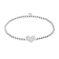 Silver bracelet with a heart-shaped charm on a white background