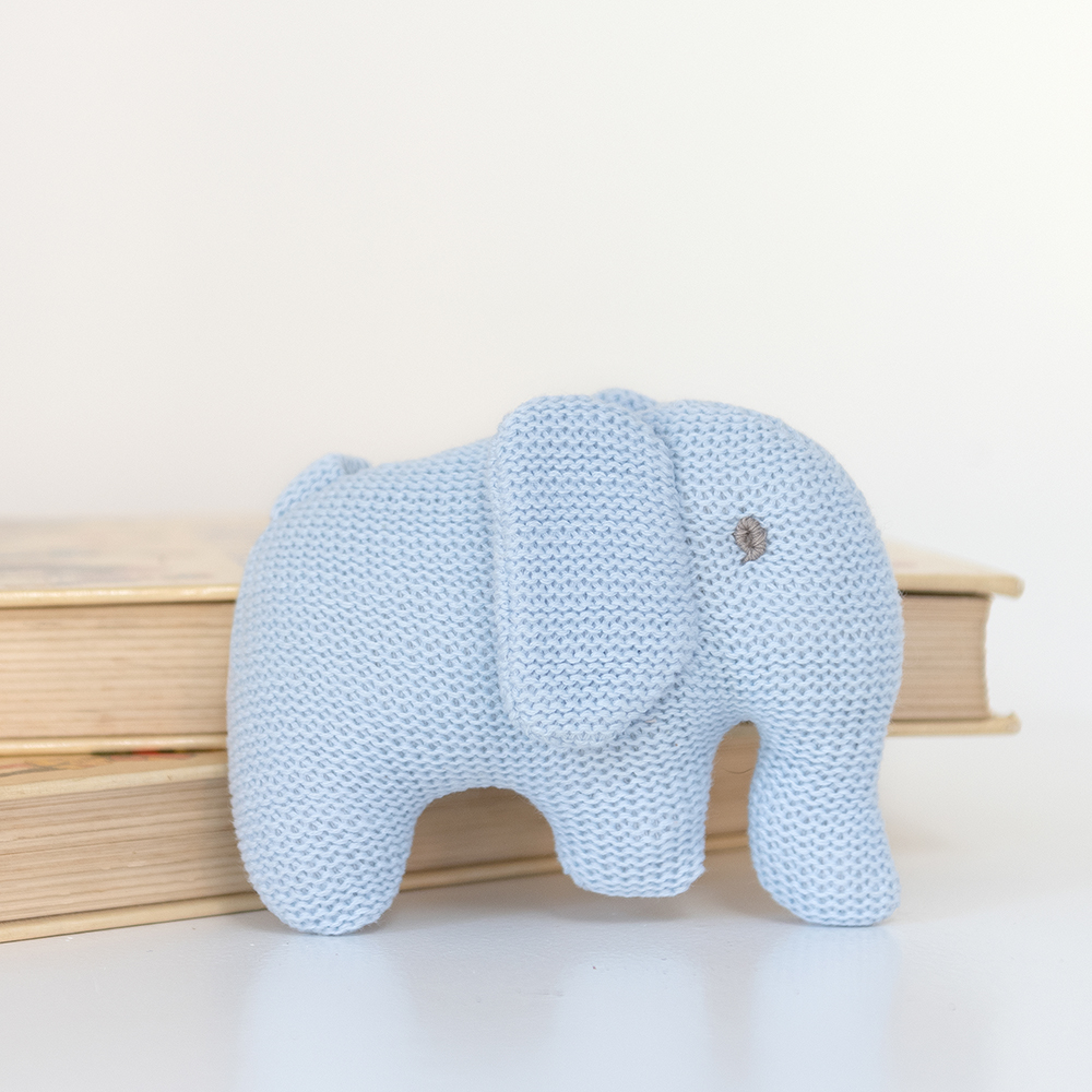 Knitted blue elephant toy on a white background