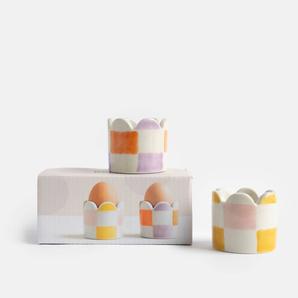 Set of colorful ceramic egg cups on a white background