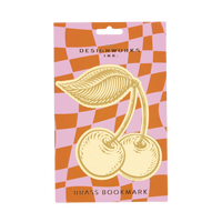 Packaged brass bookmark with cherry design on a checkered background