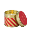 Candle in a decorative tin with red and gold design, featuring the brand 'Stoneglow'.