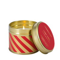 Candle in a decorative tin with red and gold design, featuring the brand 'Stoneglow'.