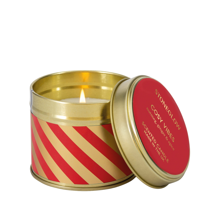 Candle in a decorative tin with red and gold design, featuring the brand 'Stoneglow'.
