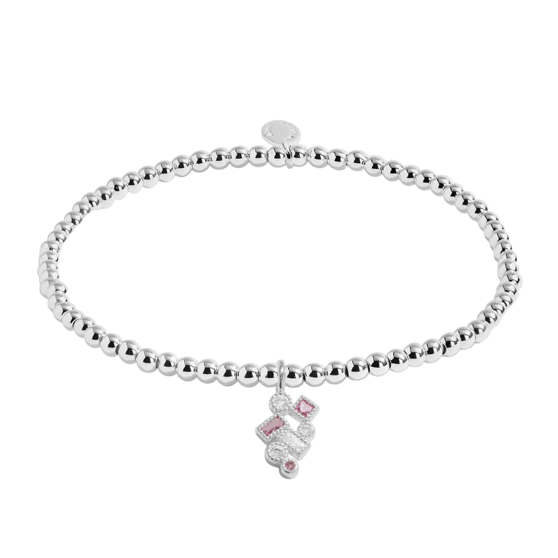 Silver bracelet with a pink heart charm on a white background