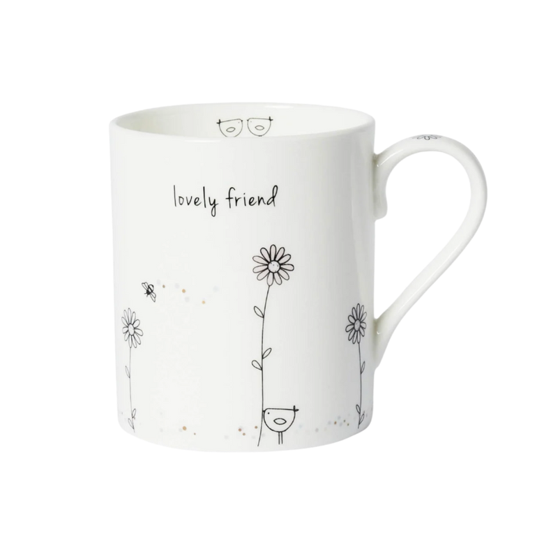White mug with black floral designs and 'lovely friend' text on a white background