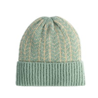Green knit beanie with white stripes on a white background