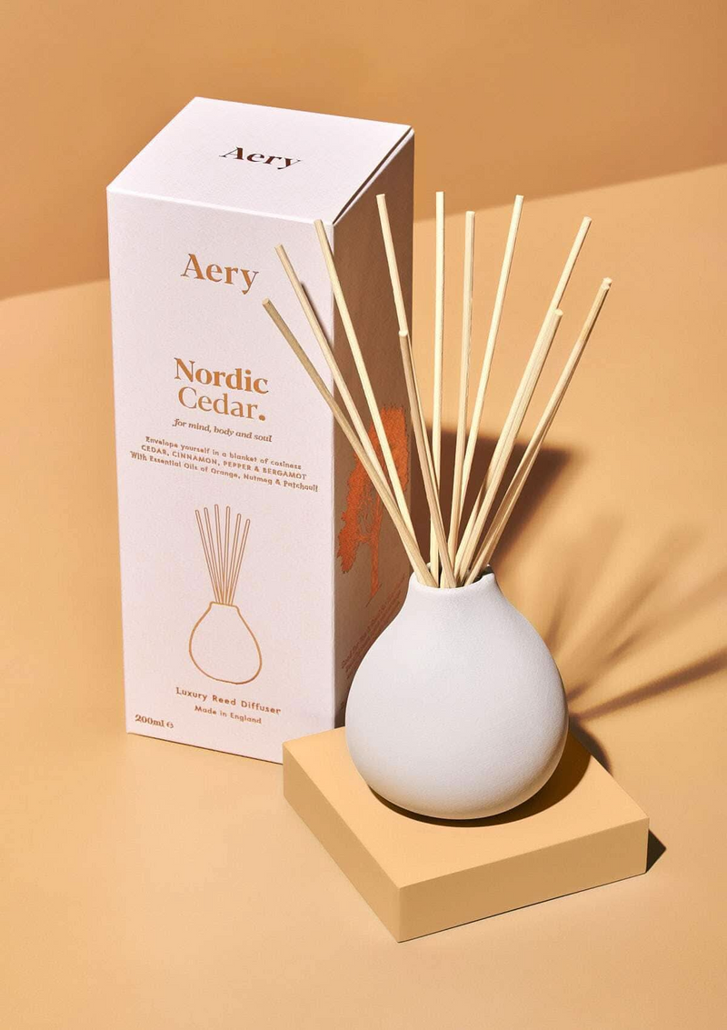 Aery Nordic Cedar diffuser with packaging on a beige background