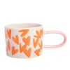 Mug with orange heart patterns on a white background