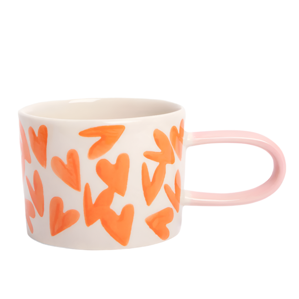 Mug with orange heart patterns on a white background