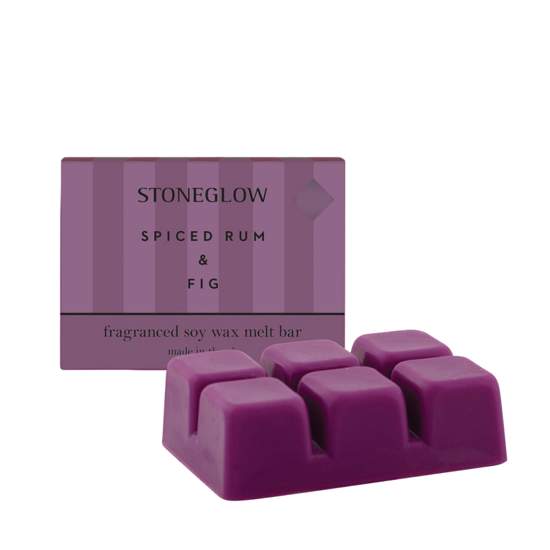 Purple wax melt bar with packaging labeled 'Stoneglow Spiced Rum & Fig' on a white background