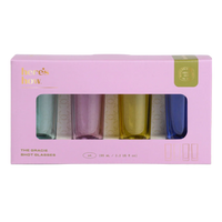 Set of 4 colourful shot glasses in a pink box with 'here's how' branding.