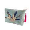 Light blue pouch with embroidered birds and a pink tassel on a white background