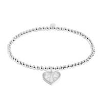 Silver bracelet with a heart-shaped charm on a white background
