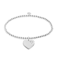 Silver bracelet with a heart-shaped tag on a white background
