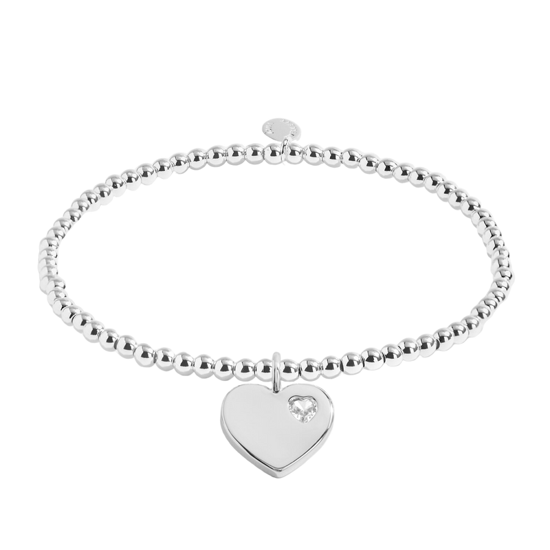 Silver bracelet with a heart-shaped tag on a white background