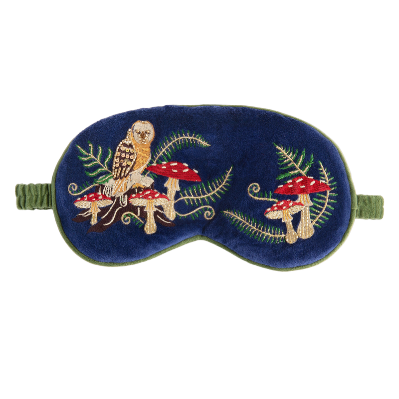 Embroidered eye mask with owl and mushroom design on a blue background